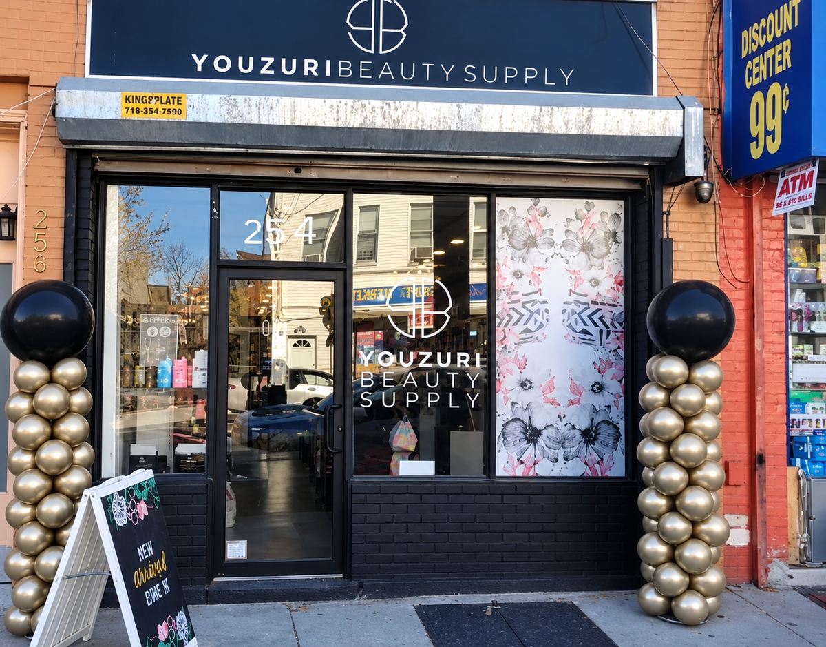 Youzuri Beauty Supply storefront with black and gold balloon columns framing the entrance.